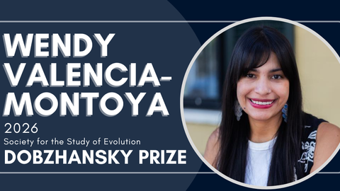 Rectangular dark blue graphic announcing an award. On the left, large white text reads “Wendy Valencia-Montoya” and below in smaller text “2026 Society for the Study of Evolution Dobzhansky Prize.” On the right is a circular photo of a smiling person with long straight dark hair and bangs, wearing dangling earrings and a black patterned vest over a white top, against a blurred indoor–outdoor background.