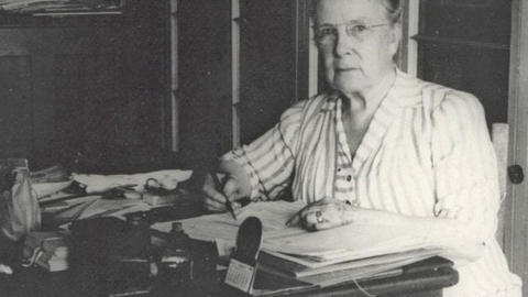 black and white image of a person at a desk