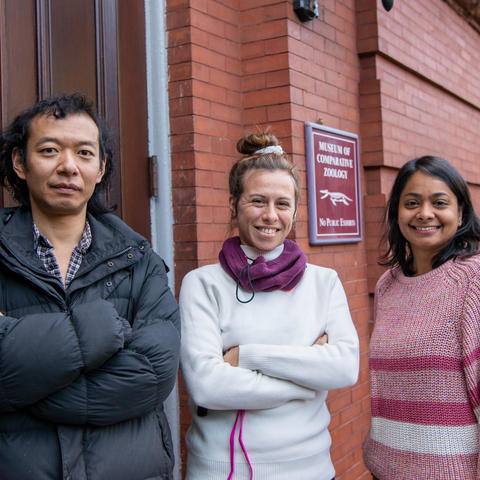 three people outside, smiling at the camera