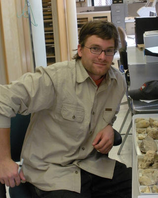 a person looking at the camera, sitting in a lab setting