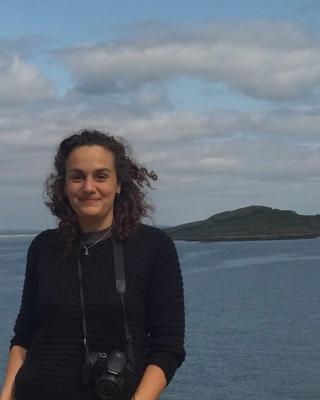 A person outside, in front of water