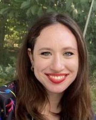 a person outside, smiling at the camera