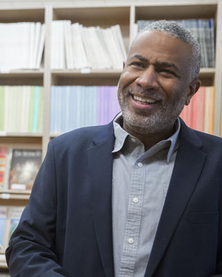 a person standing in front of a bookcase