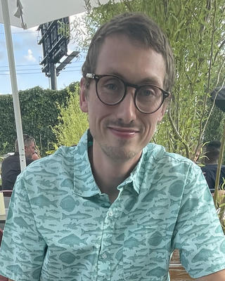 a person outside, looking at the camera.