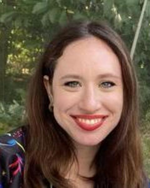 a person outside, smiling at the camera